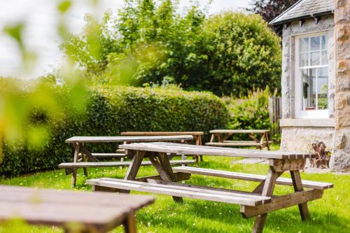 a group of picnic tables in the grass at Whitebridge Hotel in Whitebridge