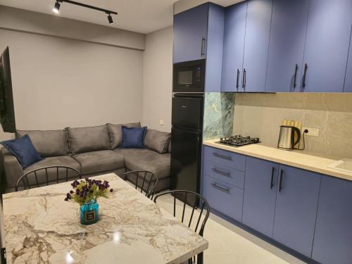 a kitchen with a table and a couch in a room at Mariana in Gori