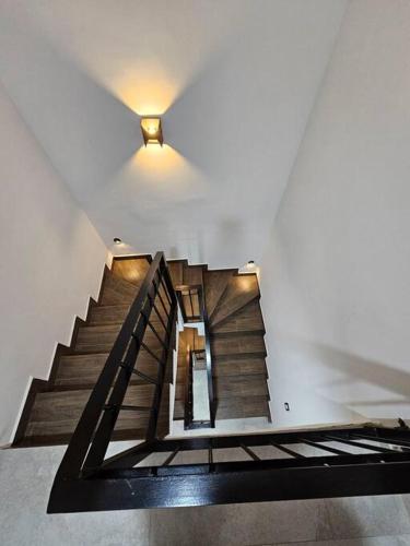 a staircase in a building with a light on the ceiling at Casa Angulo 8 Guest Gated Home in Viñedos Del Mar in El Suazal