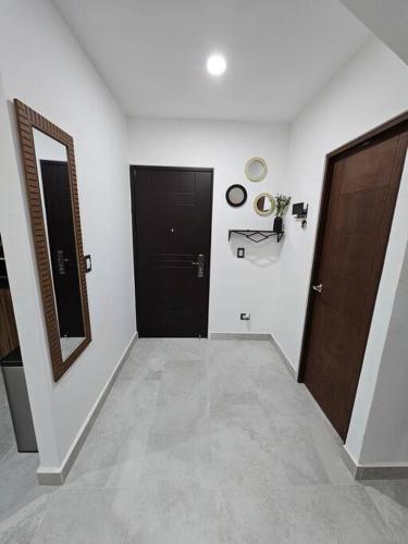 a hallway with two doors and a mirror and a hallway sidx sidx sidx at Casa Angulo 8 Guest Gated Home in Viñedos Del Mar in El Suazal