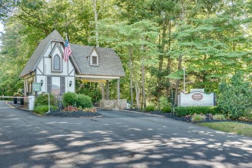 a house with an american flag on a road at Hot Tub and EV Charger Helen Getaway with Views! in Helen