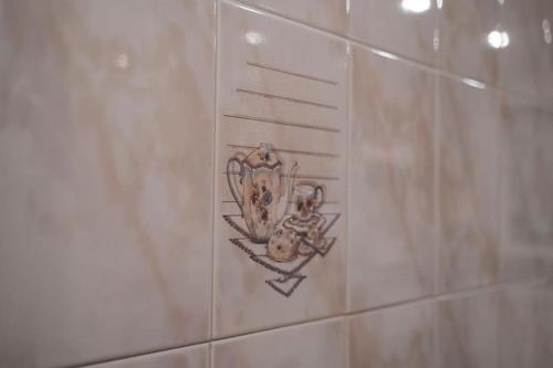 a tiled wall with a drawing on the wall at Villa Flaviae in Chaves