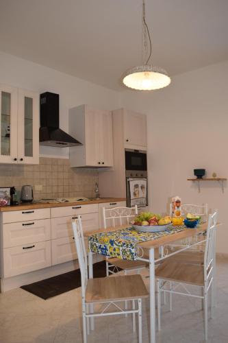 una cucina con un tavolo con una ciotola di frutta sopra di Villa Rosi a Isola delle Femmine