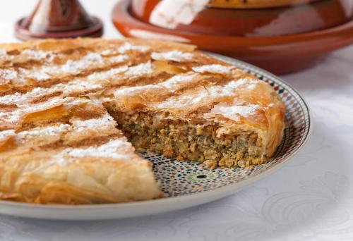 a piece of cake on a plate on a table at Palais Nazha Fes - Luxury Lodging in Fès