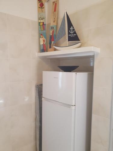 a white refrigerator with a shelf on top of it at Da Vinci kavouropetra in Aegina Town
