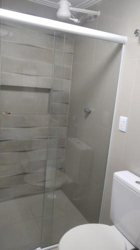 a glass shower in a bathroom with a toilet at Pousada Villa Goyá in São José da Coroa Grande