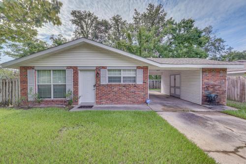 a red brick house with a white garage at Baton Rouge Home with Yard about 14 Mi to Downtown! in Baton Rouge
