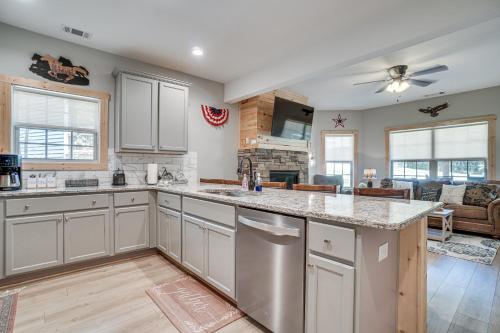 a kitchen with stainless steel appliances and a living room at Hot Tub and EV Charger Helen Getaway with Views! in Helen