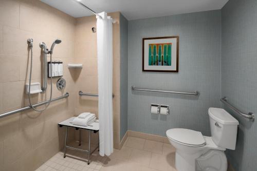 a bathroom with a toilet and a shower at Hyatt Place Portland Airport/Cascade Station in Portland