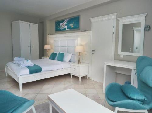 a bedroom with a bed with blue pillows at Villa Bella Luxury Ohrid in Ohrid