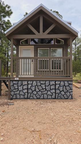 a small house with a stone wall at Cabin with a Mountain view 6B in Williams