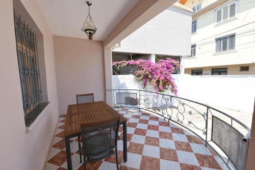 a balcony with a table and a checkered floor at Fishta Villa and Apartments in Shkodër