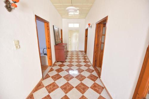 a hallway with a checkered floor in a house at Fishta Villa and Apartments in Shkodër