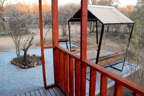 a porch with a gazebo and a tree at Thirty-Three Dinokeng Big 5 in Klipdrift