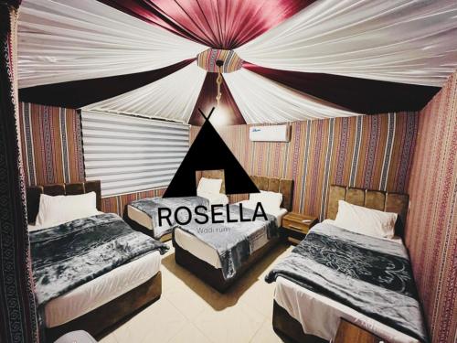 a hotel room with two beds and a tent at ROSELLA Wadi Rum in Disah