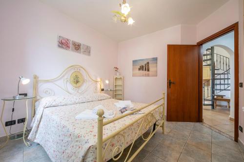 a bedroom with a bed with a white bedspread at Villa Monte Enrico - Pool And Whirlpool - Happy Rentals in Camporosso