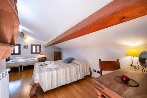 a bedroom with a bed and a table in a room at Villa Monte Enrico - Pool And Whirlpool - Happy Rentals in Camporosso