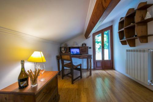 a living room with a bottle of wine and a table at Villa Monte Enrico - Pool And Whirlpool - Happy Rentals in Camporosso