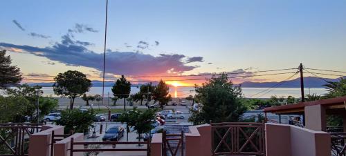 a view of a parking lot with a sunset in the background at Akrotiri Apartments Pefki Evia in Pefki