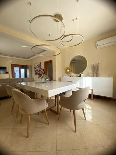 a dining room with a white table and chairs at Casa7pias in Ponte de Lima