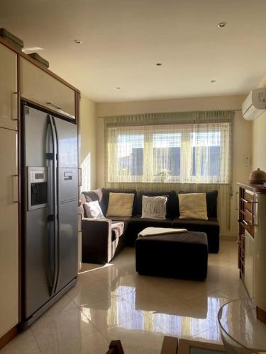 a living room with a couch and a refrigerator at Casa7pias in Ponte de Lima