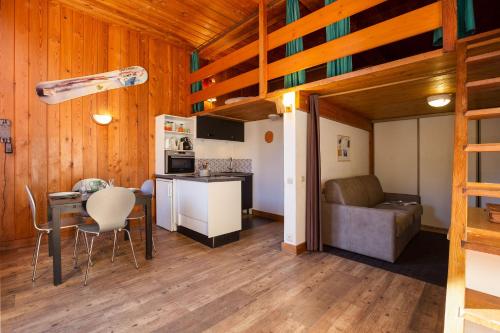 une cuisine et un salon avec une table et un canapé dans l'établissement Résidence Grand Roc - Studio 708 - Happy Rentals, à Chamonix-Mont-Blanc