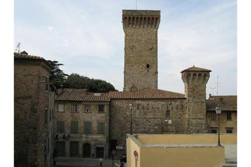 an old building with two towers on top of it at Family Friendly Villa Giulia with pool - Happy Rentals in Lucignano