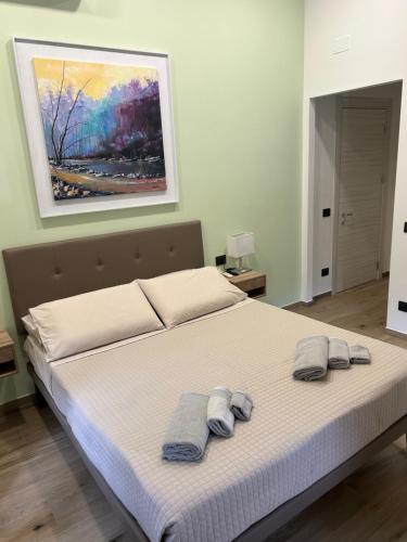 a bedroom with a bed with two towels on it at Ulivo House in Genova