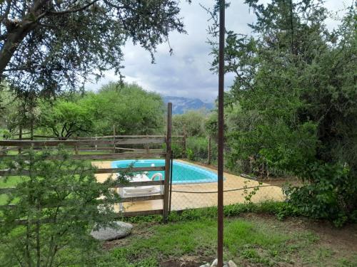 a fence around a swimming pool in a yard at Casa Tulisquin in Merlo
