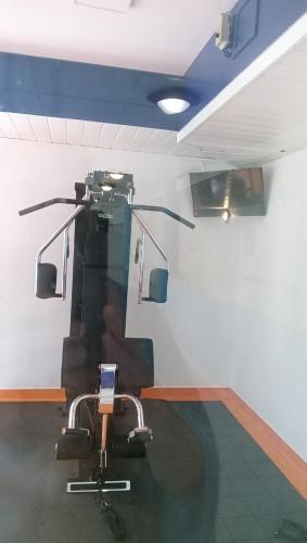 a barber shop with a chair in a room at Le Repaire du Golfeur de la Largue - Mooslargue in Mooslargue