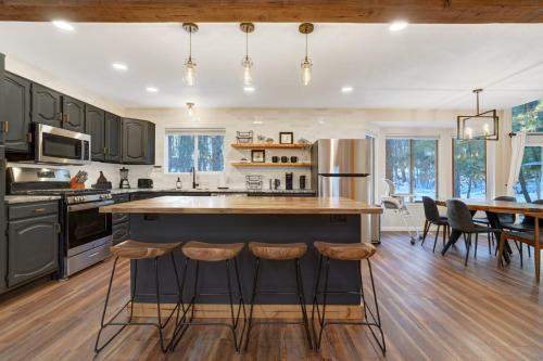 a kitchen with a large island with bar stools at Fox Run Retreat Hot Tub & Fire Pit & BBQ in Colorado Springs