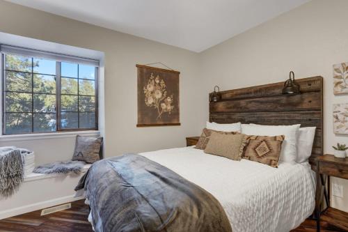 a bedroom with a large bed and a window at Fox Run Retreat Hot Tub & Fire Pit & BBQ in Colorado Springs