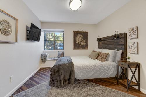 a bedroom with a bed and a window at Fox Run Retreat Hot Tub & Fire Pit & BBQ in Colorado Springs