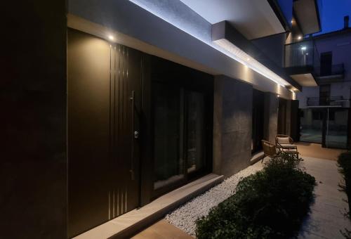 a building with a door and a bench on a patio at La Ginestra C&B House and Rooms in Castel di Sangro