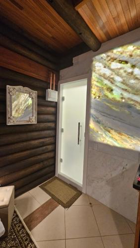 a door in a room with a painting on the wall at Aldeia Flor de Liz - Pedra Azul in Pedra Azul