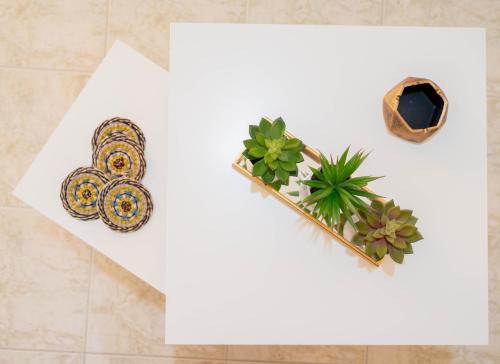 a white paper with two pins and a plant at G&G Apartment in Kiáton