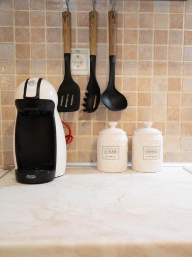 a kitchen counter with knives and utensils on a wall at G&G Apartment in Kiáton