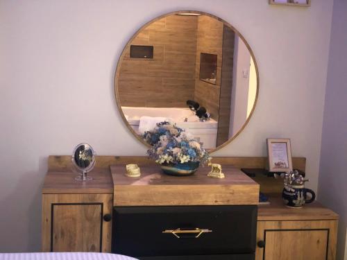 a bathroom with a sink and a mirror at Deluxe Apartment In City Center in Tirana