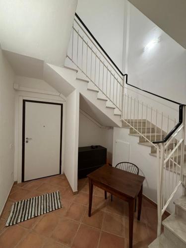 a living room with a staircase and a table at I Borghetti in San Zaccaria