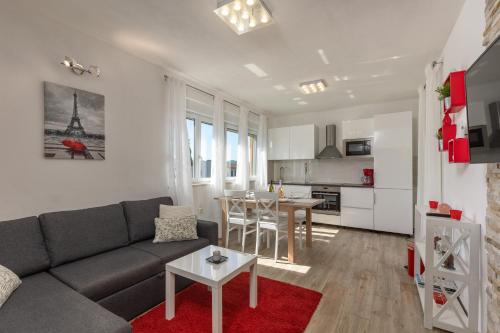 a living room with a couch and a table at Holiday Home Aurea - Happy Rentals in Labin