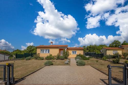 a house on a hill with a driveway at Holiday Home Aurea - Happy Rentals in Labin