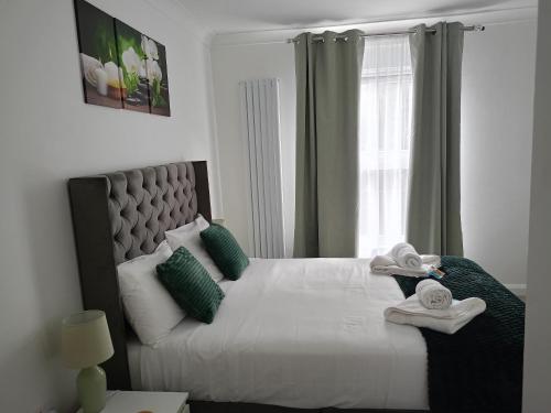 a bedroom with a bed with towels on it at Prestige in Cambridge