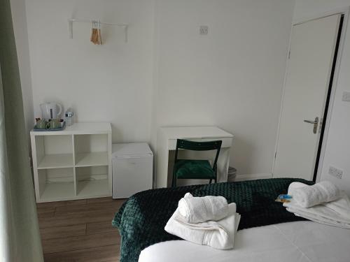 a bedroom with a bed with two towels on it at Prestige in Cambridge