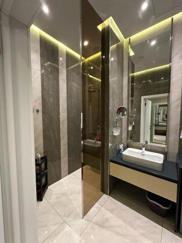 a bathroom with a sink and a mirror at Sea Breeze Light House 2 Studio Apartment in Baku