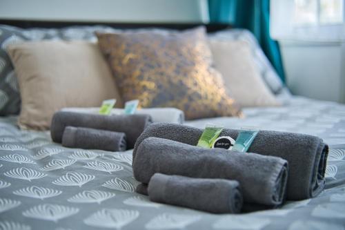 a group of gray towels on a bed at MODERN LONDON DOUBLE Bedroom in London