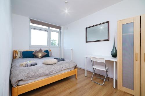 a bedroom with a bed and a desk at MODERN LONDON DOUBLE Bedroom in London