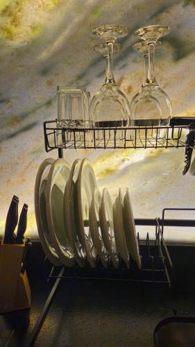 a rack of plates and glasses on a table at Aldeia Flor de Liz - Pedra Azul in Pedra Azul