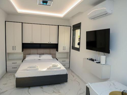 Ένα ή περισσότερα κρεβάτια σε δωμάτιο στο Merlin Prestige Apartments
