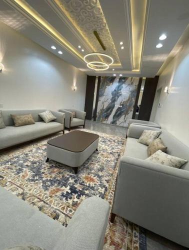 a living room with couches and a coffee table at شقة فاخرة بأبها in Abha
