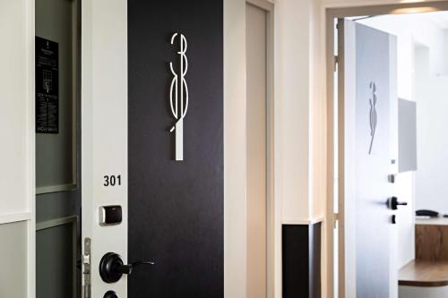 a door with a sign on it next to a room at Best Western Premier The Blake Paris Gare Saint Lazare in Paris